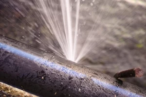 black pipe bursting with water leak